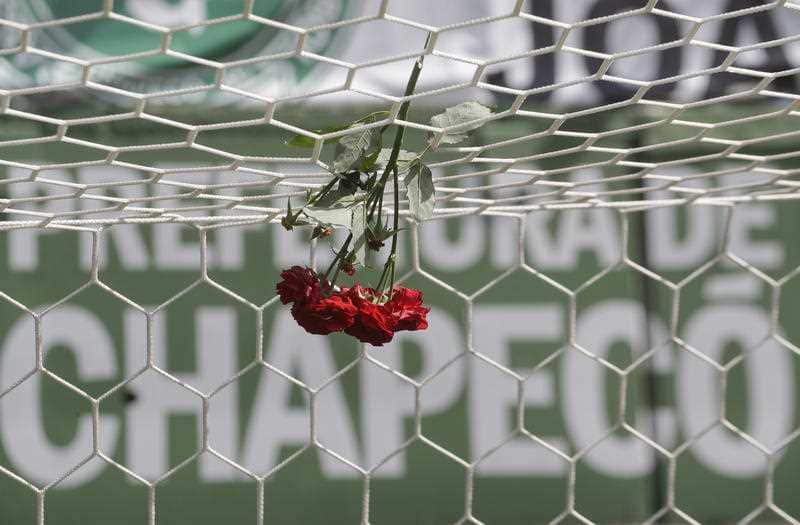 Flowers hang from a soccer net at the Arena Conda stadium in Chapeco, Brazil