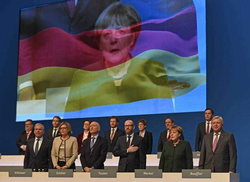 The Christian Democratic Party's board sings the national anthem at the general party conference.