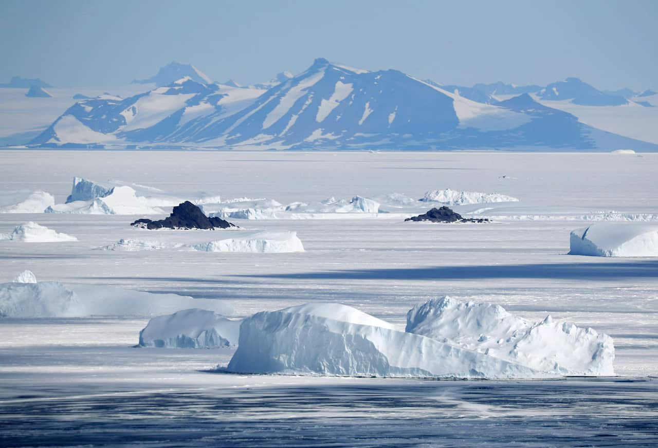 Mountains in Antarctica and ice floating in the Antarctic Sea.