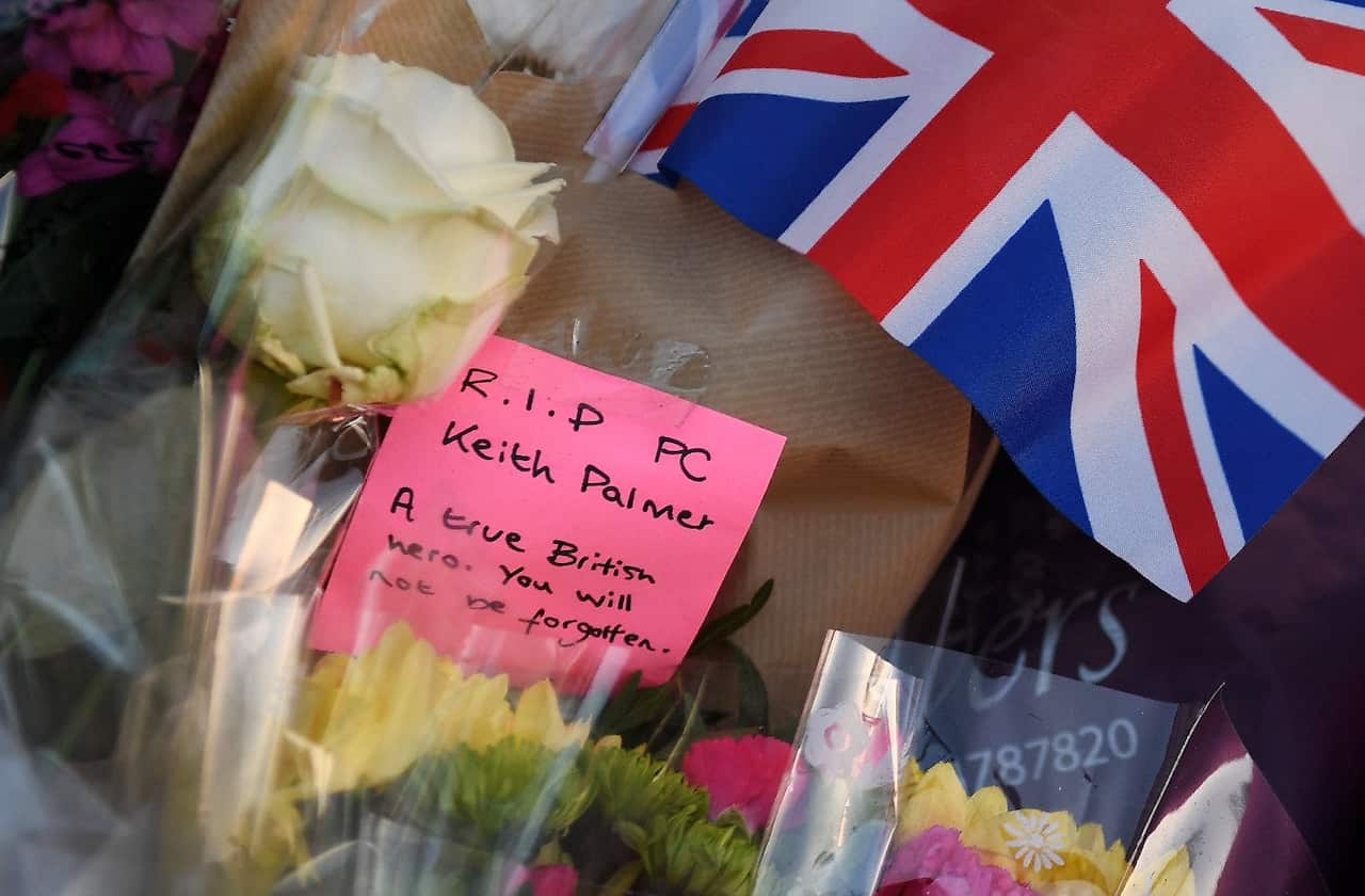 A message is left with flowers in tribute to Keith Palmer