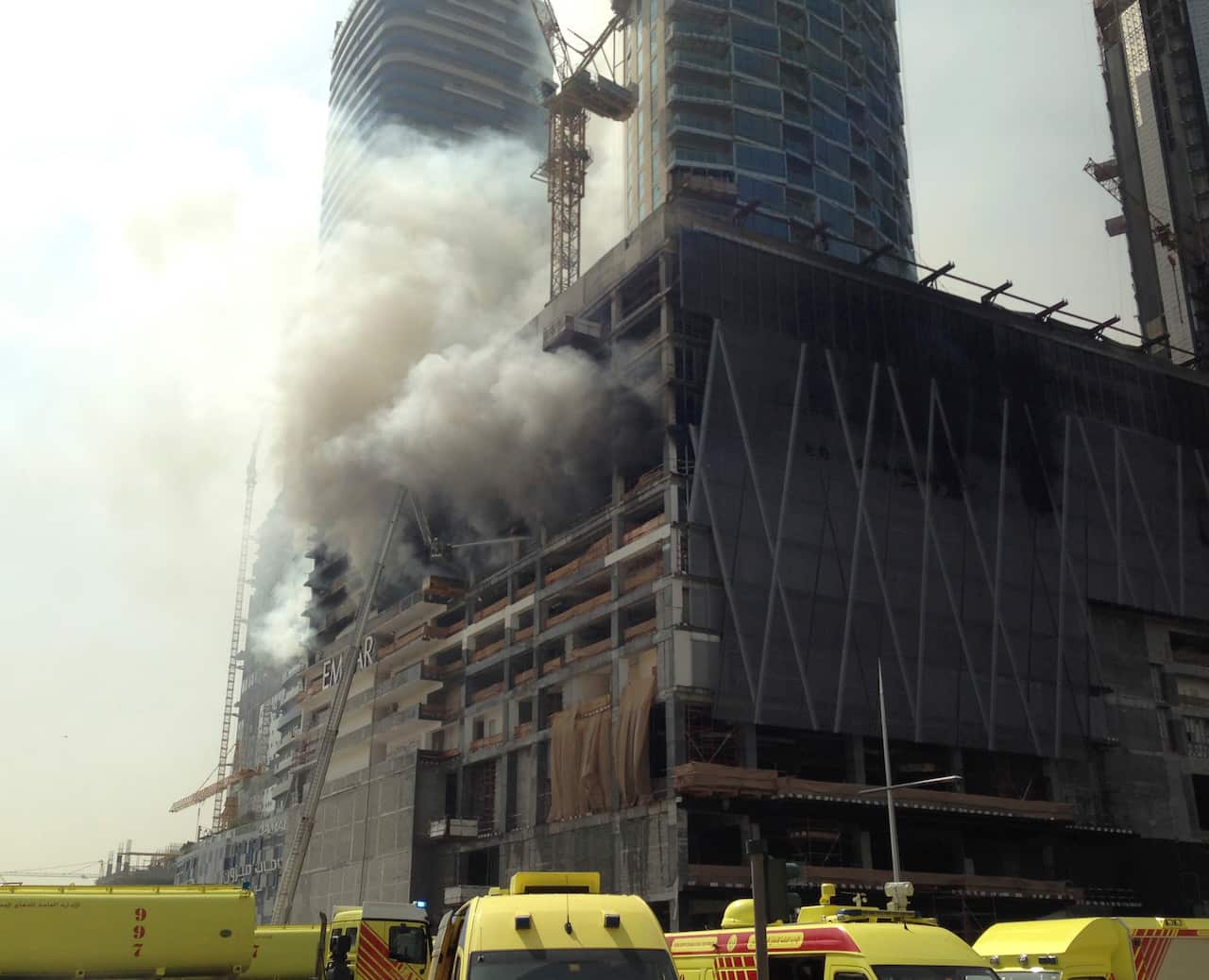 Firefighters battle a fire at the under-construction Fountain Views tower next to Dubai Mall.