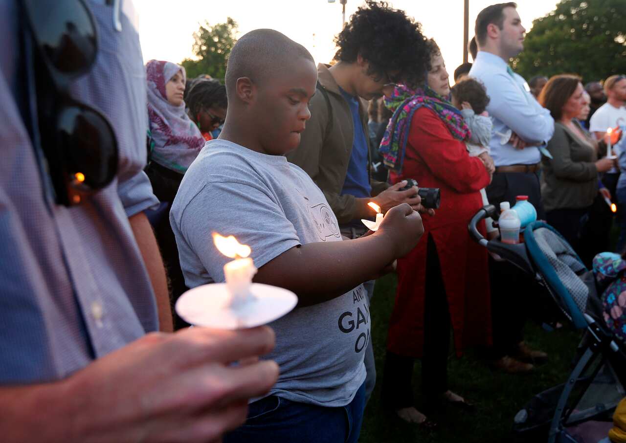 People hold candles during a vigil for Jordan Edwards on May 4, 2017.