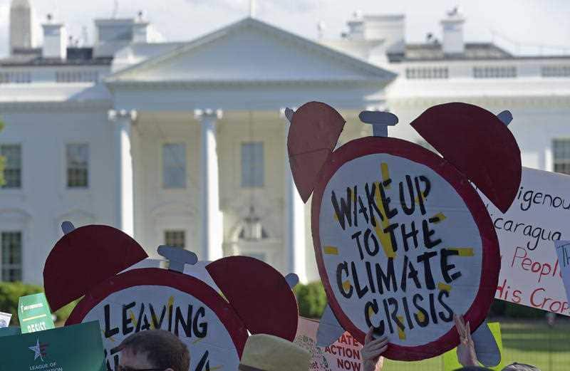 Protesters gather outside the White House in Washington, Thursday, June 1, 2017, to protest President Donald Trump's decision to withdraw the Unites States from the Paris climate change accord.