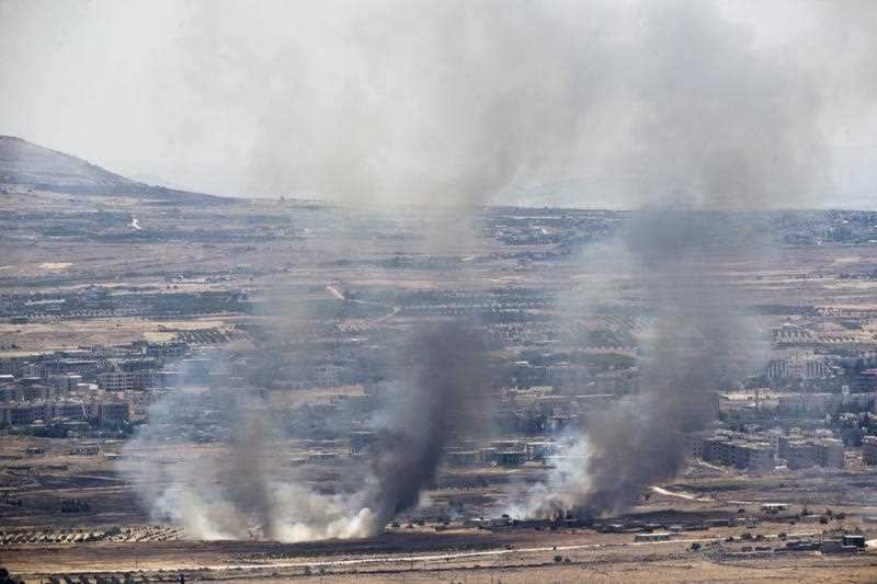 Smoke rise from Syrian village as a result of fighting near the city of Quneitra, in the Golan Heights