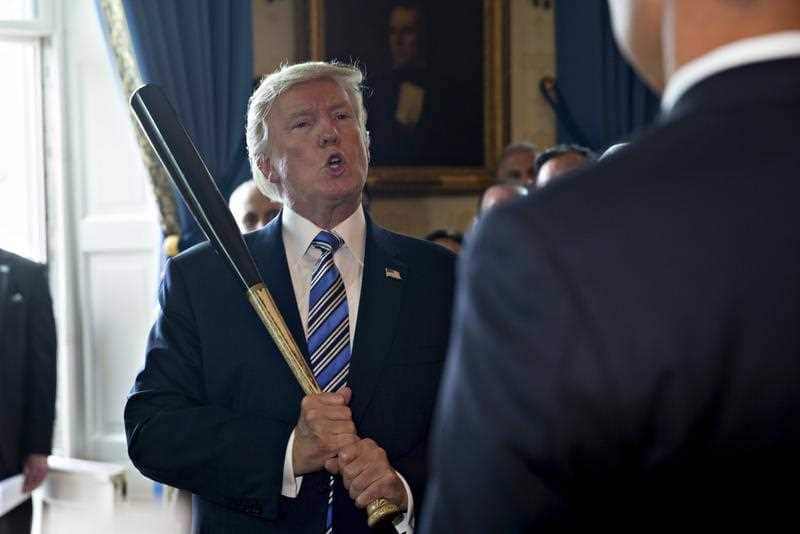 US President Donald J. Trump holds a baseball bat while participating in a Made in America event.