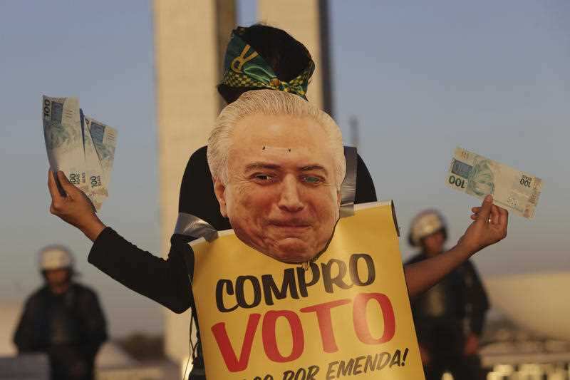 Image: woman protests in front of Congress in Brazil