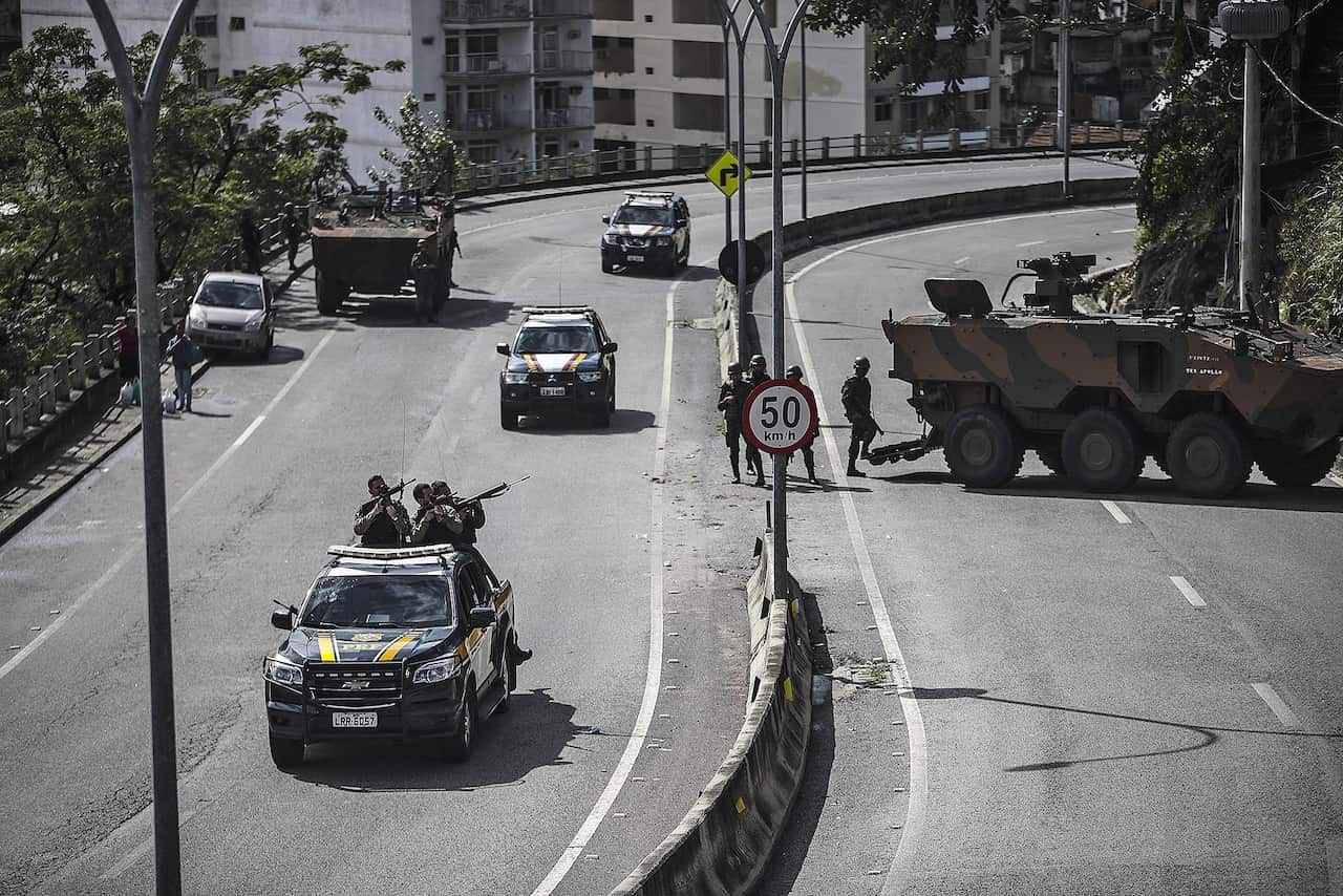 Armed forces of the Brazilian Federal Highway Police take position during an operation against organised crime in Rio de Janeiro.