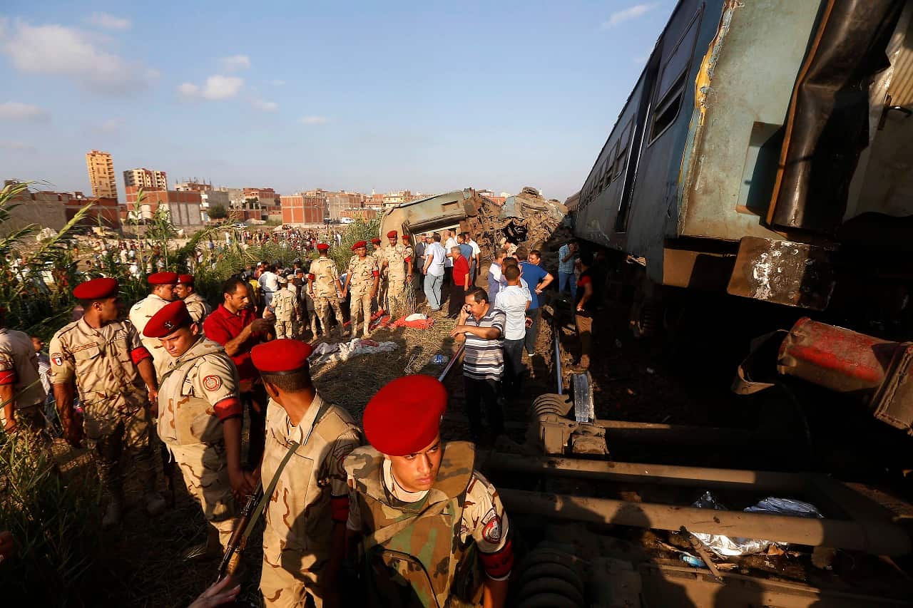 Army attend the scene of a train collision just outside Egypt's Mediterranean port city of Alexandria.
