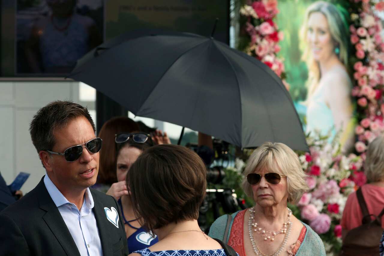 Don Damond speaks with well-wishers at a memorial held for Justine. 