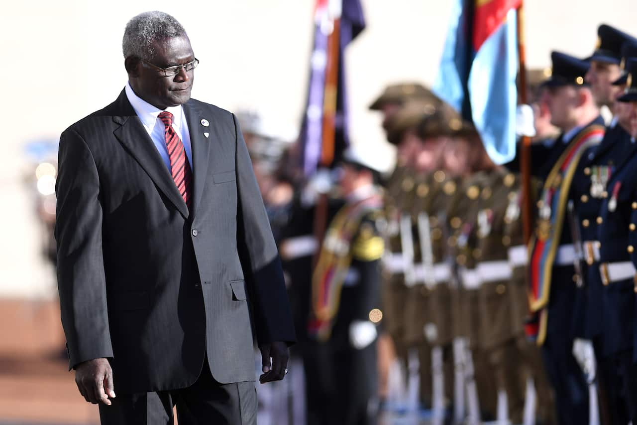 Prime Minister of the Solomon Islands Manasseh Damukana Sogavare inspects the guard of honour during a ceremonial welcome at Parliament House in Canberra, Monday, August 14, 2017.  (AAP Image/Lukas Coch) NO ARCHIVING