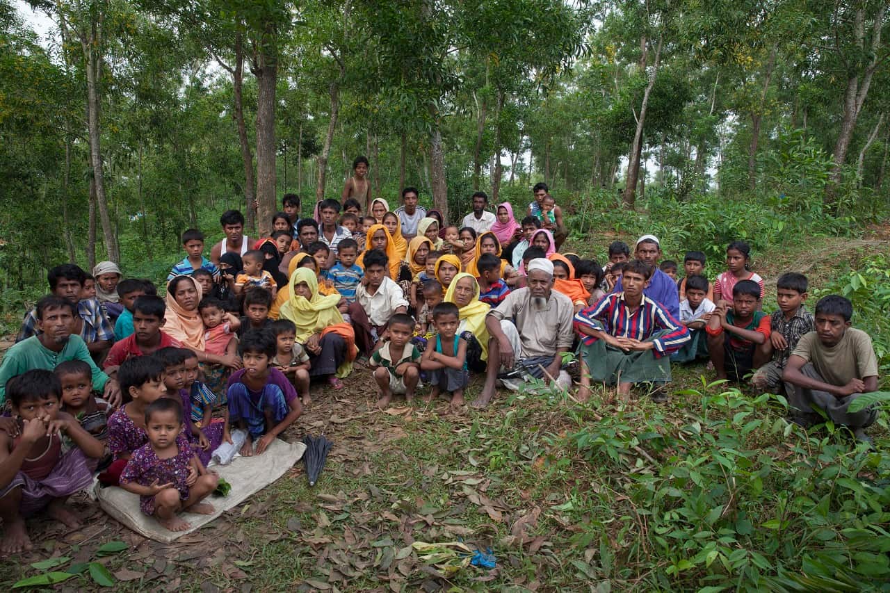 Rohingya Muslims sit after crossing over to Bangladesh near the Bangladesh-Myanmar border before going to a shelter camp at Teknaf, Bangladesh, 06 Sept 2017.