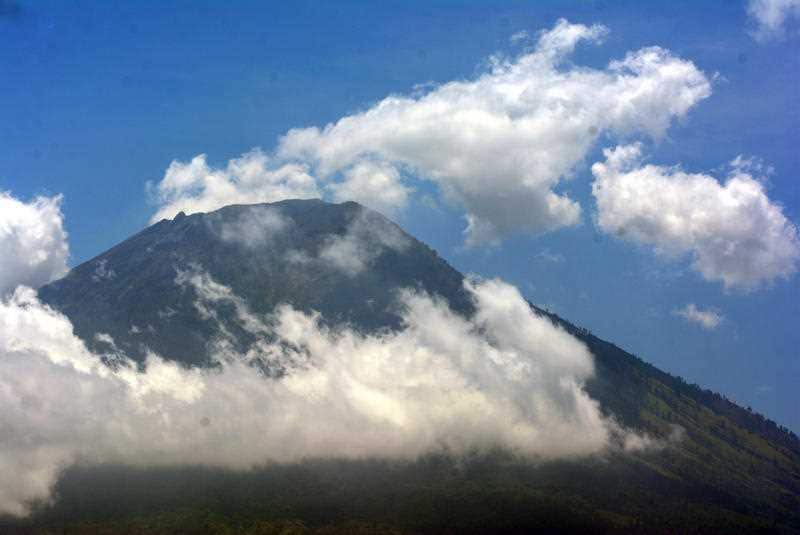 The Mount Agung is seen from the Purahayu village in Karangasem, Bali, Indonesia on 27 September 2017. Indonesian authorities declared a state of emergency as hundreds of tremors are recorded at Bali's Mount Agung volcano.