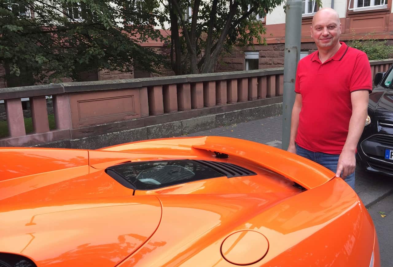 Markus Zahn stands at his sportscar in Giessen, Germany, Thursday, Sept. 28, 2017. 