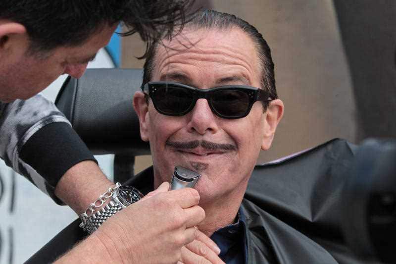 INXS musician Kirk Pengilly, a prostate cancer survivor, has his signature moustache shaved to prepare for the start of Movember, at Bondi Beach, Sydney