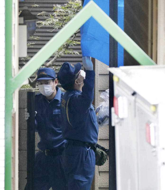 Police officers inspect an apartment complex in Zama, Kanagawa Prefecture, on Oct. 31, 2017, where nine dismembered bodies were found in an apartment earlier in the day.