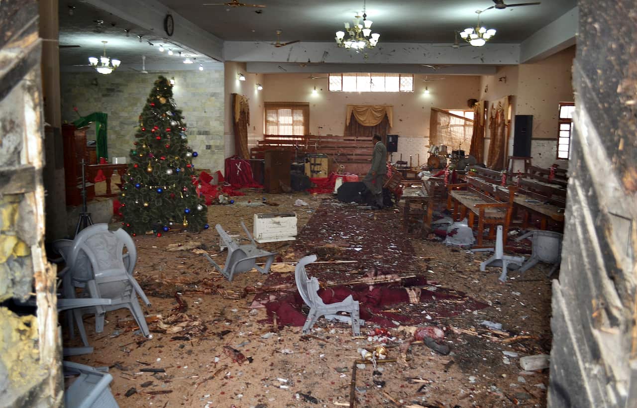 A Pakistani walks in the main hall of a church following suicide attack in Quetta.