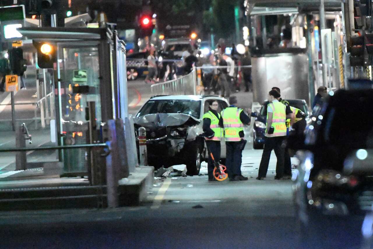 A damaged vehicle is seen at the scene of the attack on Flinders Street.