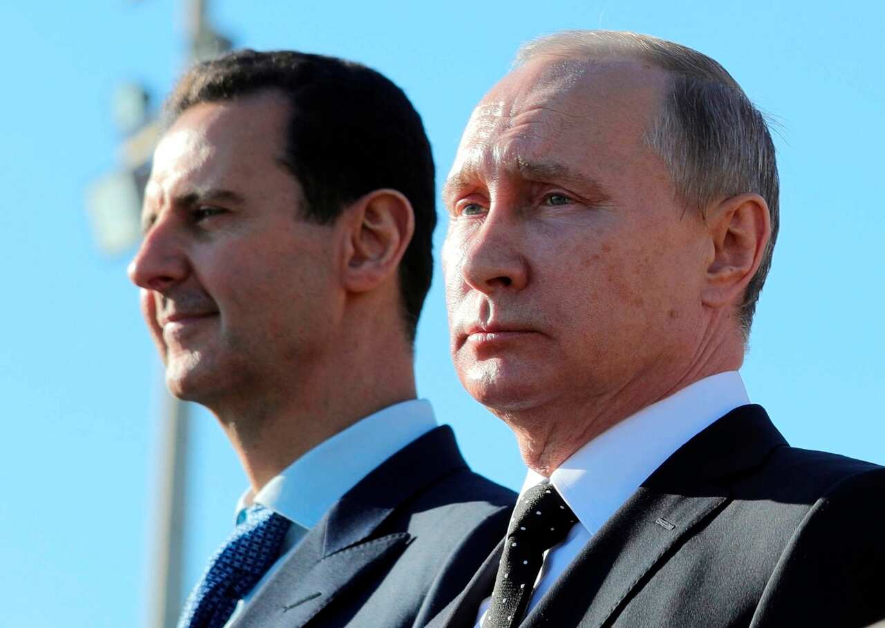 Russian President Vladimir Putin, right, and Syrian President Bashar Assad.