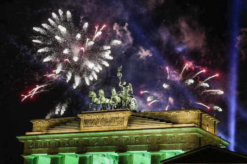Fireworks light the sky above the Quadriga at the Brandenburg Gate during New Year's celebrations shortly after midnight in Berlin, Monday, January 1, 2018.