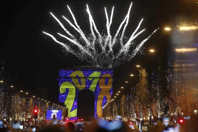 A firework explodes over the Arc de Triomphe as part of the New Year celebrations on the Champs Elysees, in Paris, France.