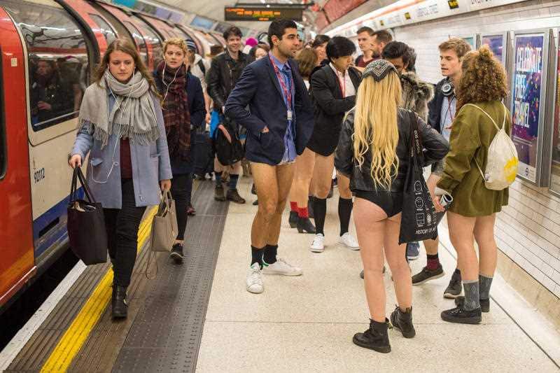People wait on the platform at Liverpool Street tube station as they take part in No Trousers on the Tube day, in London.