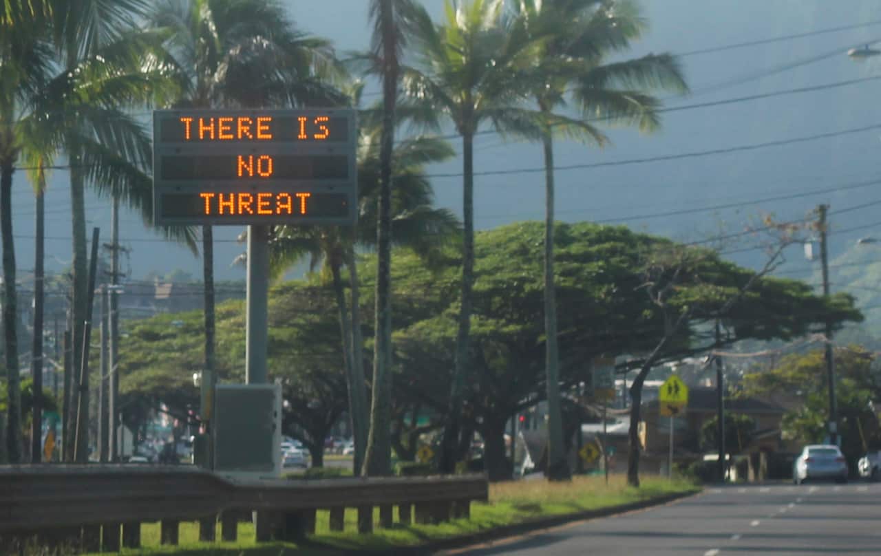A highway median sign broadcasting a message of "There is no threat" after the false alert.