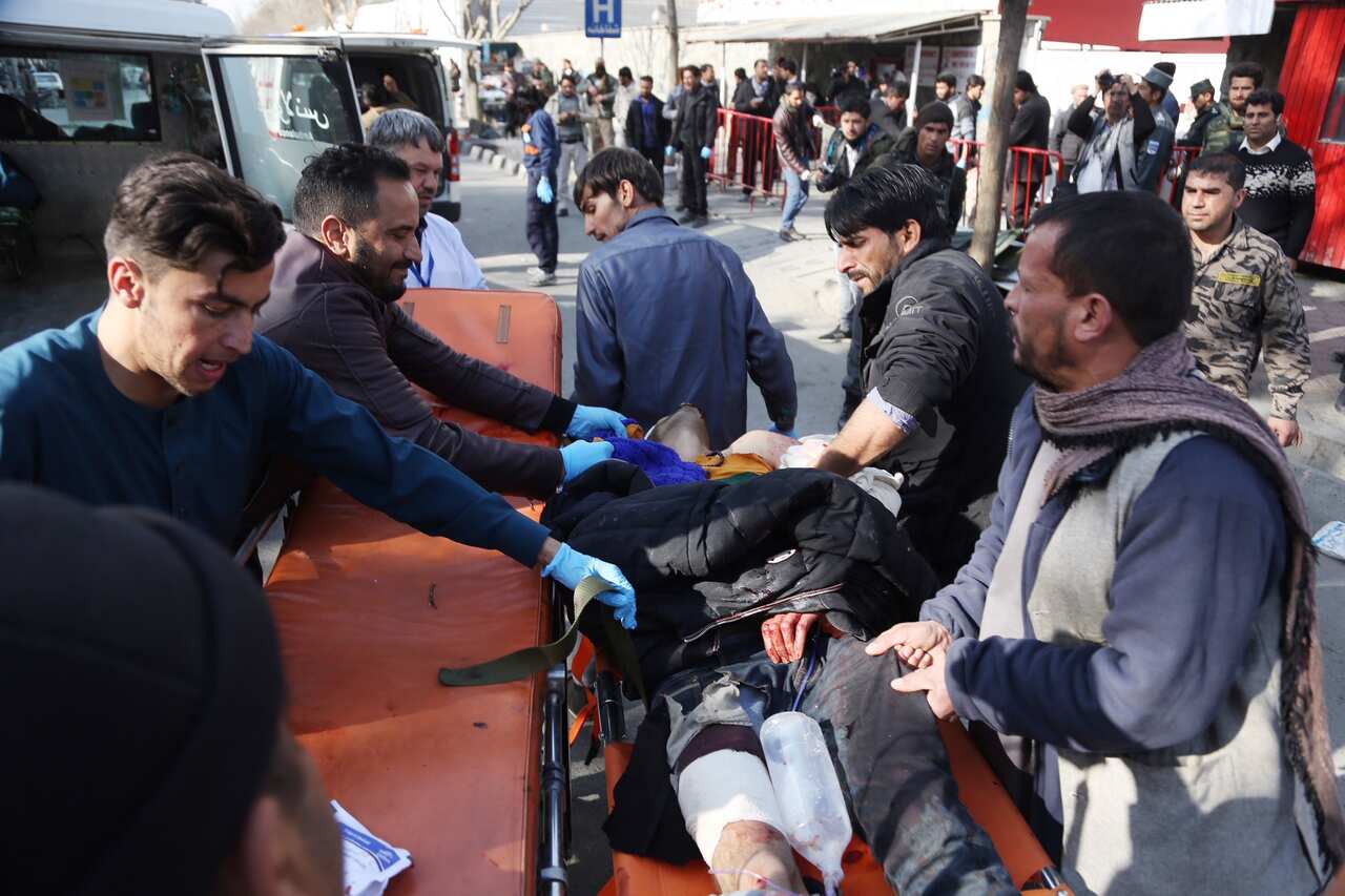 An injured man arrives at a hospital after a suicide attack in Kabul.