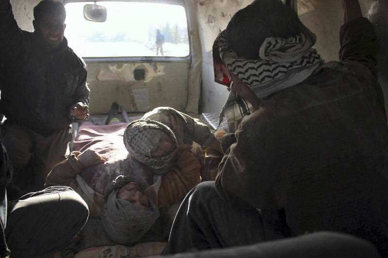 Injured people inside a Civil Defense van after airstrikes hit near Ghouta, a rebel-held suburb near Damascus, Syria.