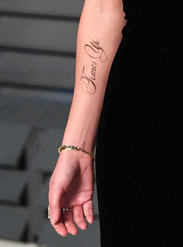 A tattoo supporting the 'Time's Up' campaign on the arm of Emma Watson as she arrives at the Vanity Fair Oscar Party.