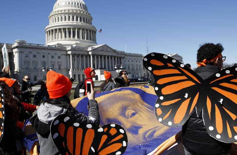 Wearing "butterfly wings," supporters of the Deferred Action for Childhood Arrivals (DACA) program march in support of DACA, Monday.