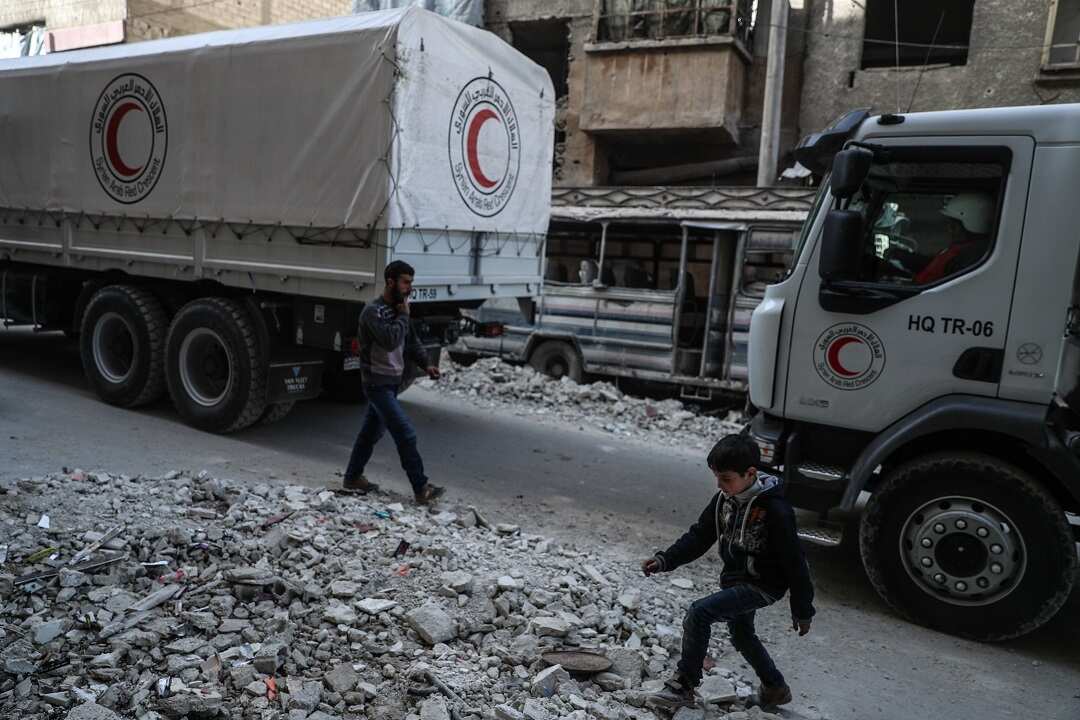 A convoy of Syrian Arab Red Crescent trucks.