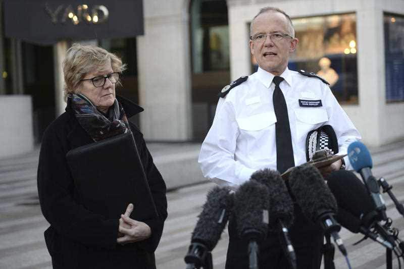 London police speaking to reporters outside New Scotland Yard.