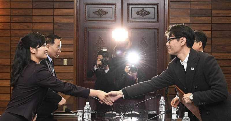 North Korean Hyon Song Wol, left, head of a North Korean art troupe, shakes hands with her South Korean counterpart Yun Sang after meeting in North Korea.