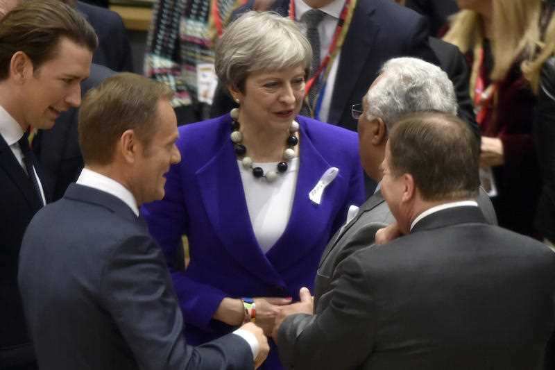 British Prime Minister Theresa May speaks with EU leaders at summit in Brussels.