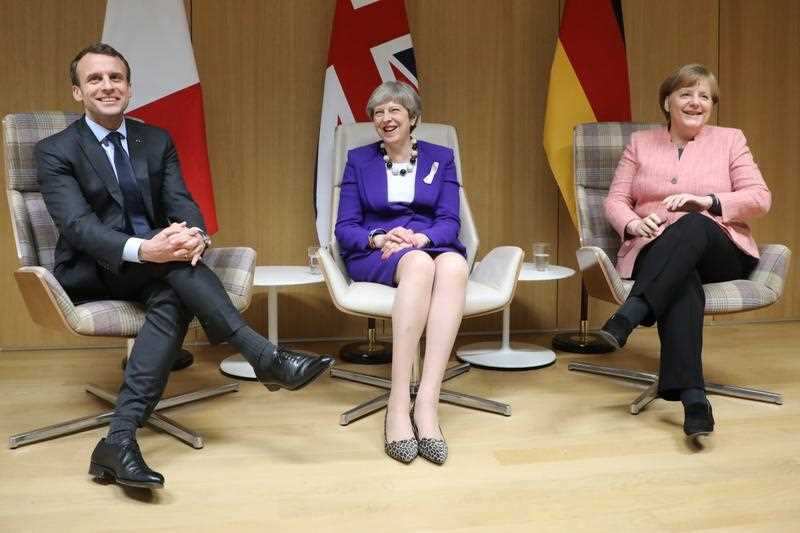 British Prime Minister Theresa May, German Chancellor Angela Merkel and French President Emmanuel Macron meet on the sidelines of an European Council.