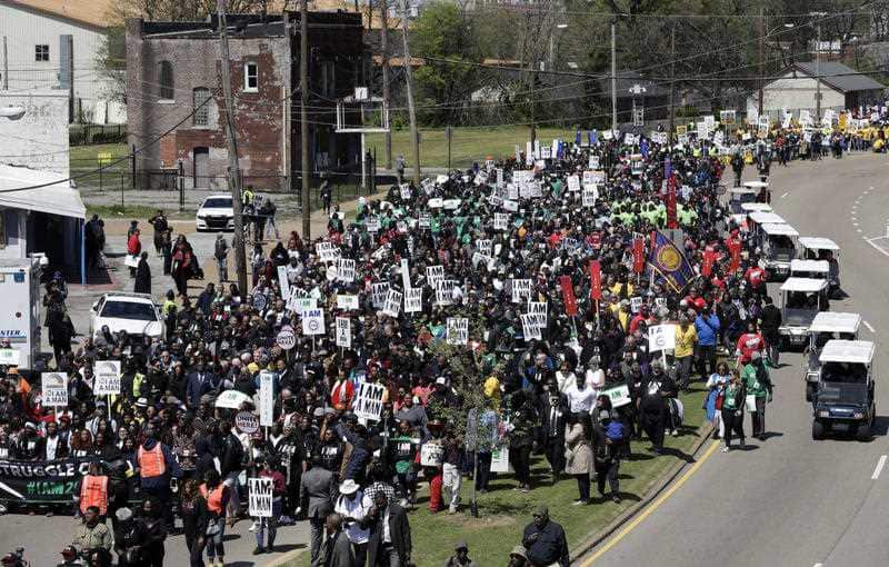 People take part in a march commemorating the anniversary of the assassination of Rev. Martin Luther King Jr. Wednesday, April 4, 2018