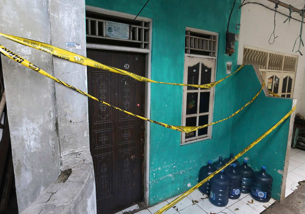 Police tape covers a home-based alcohol factory in Jakarta, Indonesia.