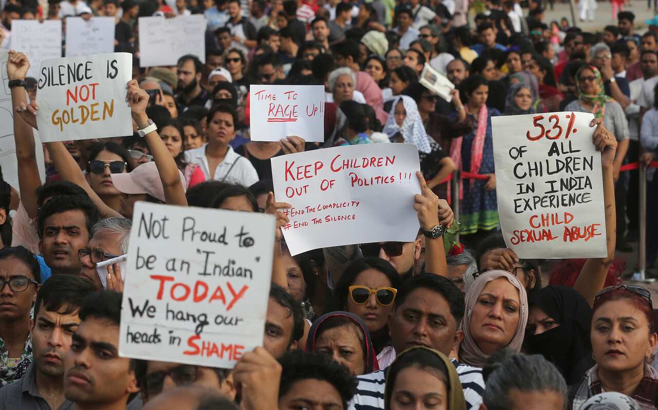 People holds play card against recent incidents of rape in the country, in Mumbai, India, Sunday, April 15, 2018
