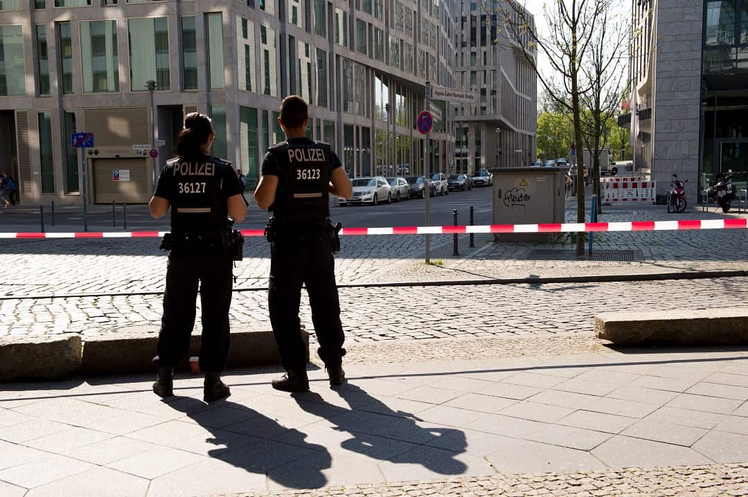 Police officers patrol the evacuated area.