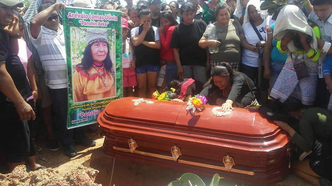People cry over the coffin of healer Olivia Arevalo during her burial in Ucayali, Peru. 