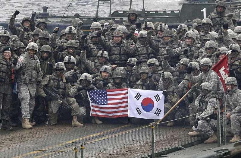 In this Dec. 10, 2015 file photo, U.S. and South Korean army soldiers pose on a floating bridge on the Hantan river during a joint military exercise.