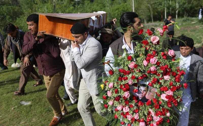 Relatives and friends attend the funeral of AFP photographer Shah Marai, who was killed in the twin bomb blasts in Kabul, Afghanistan