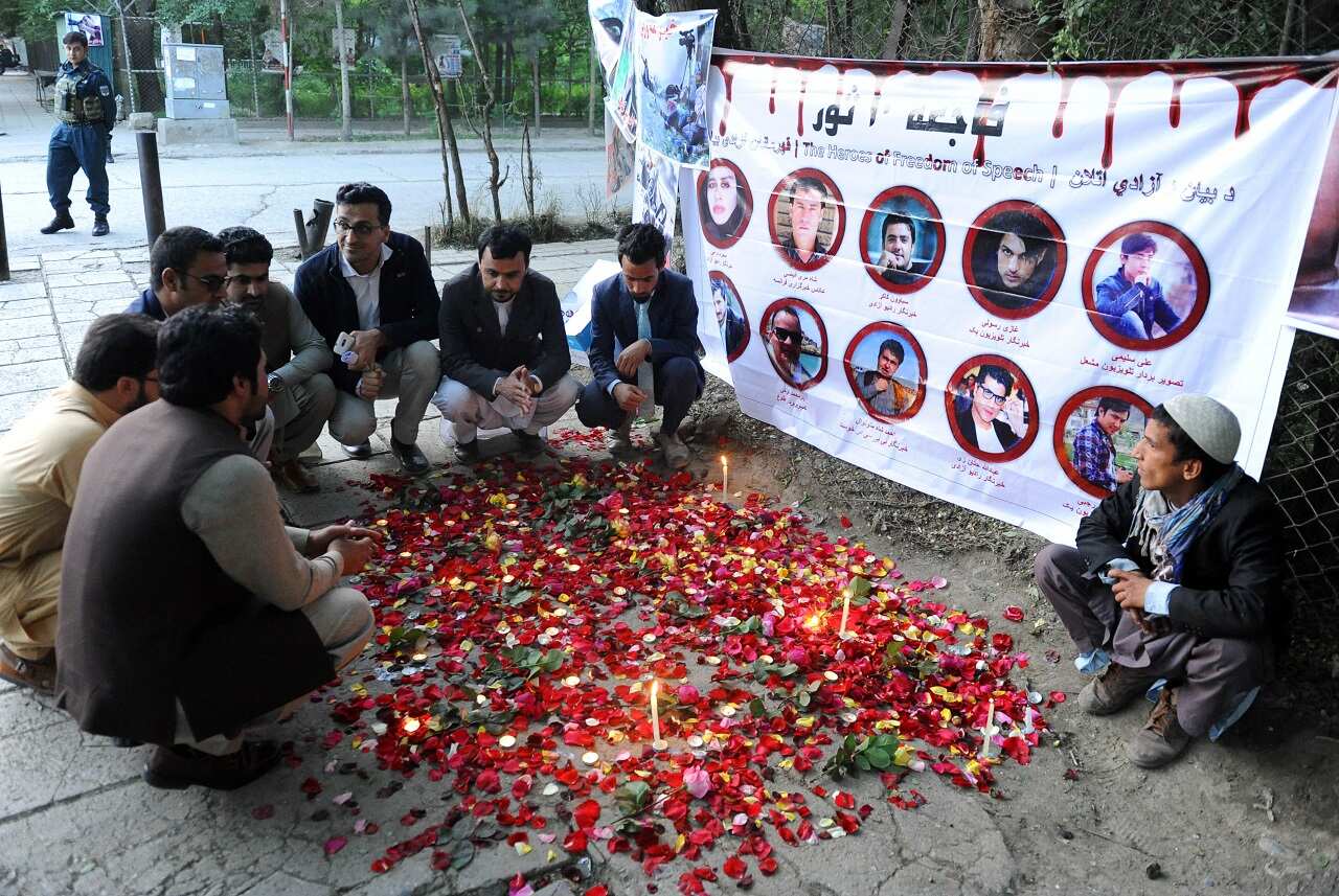 Afghan journalists light candles at the place where 24 people including 9 journalists were killed in Kabul, Afghanistan 03 May 2018. 