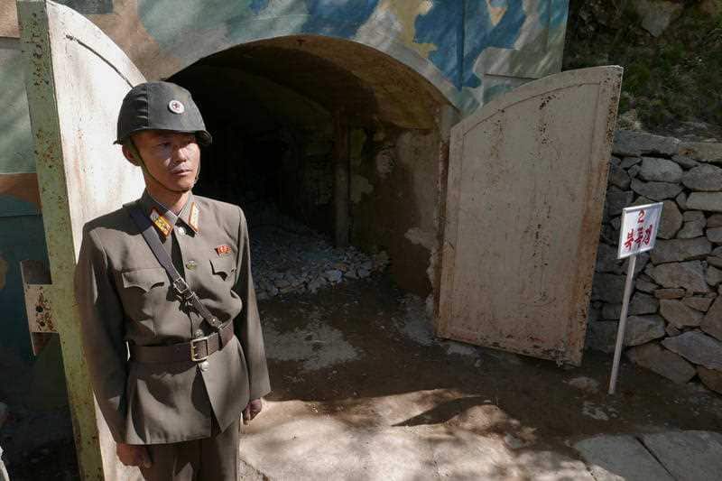 A guard stands at the entrance of the north tunnel at North Korea's nuclear test site.