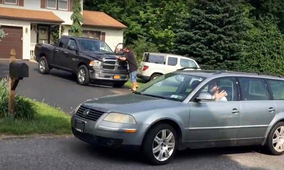 Thirty-year-old Michael Rotondo waves to the media as he leaves his parents' house in Camillus, N.Y., around 9:30 a.m. Friday, June 1, 2018.