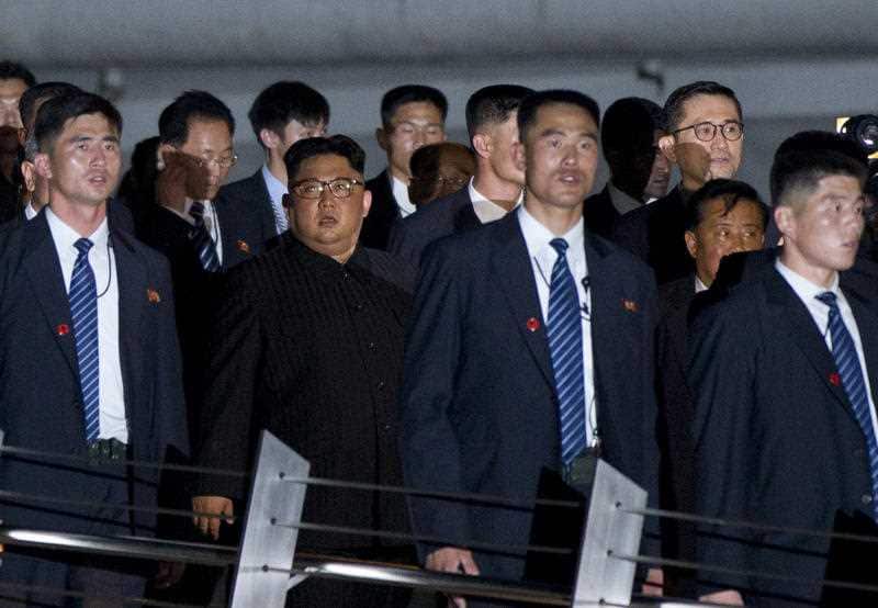 North Korean leader Kim Jong Un, center, walks in Marina Bay, Singapore Monday, June 11, 2018 ahead of the summit with US President Donald Trump.