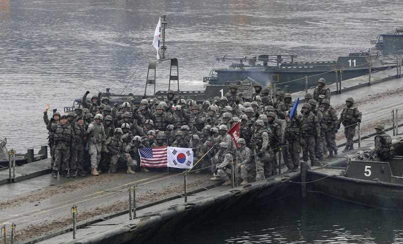 In this Dec. 10, 2015 file photo, U.S. and South Korean army soldiers pose on a floating bridge on the Hantan river after a river crossing operation, part of an annual joint military exercise between South Korea and the United States.