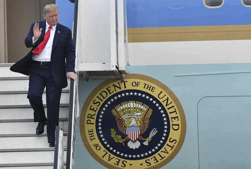 U.S. President Donald Trump disembarks Air Force One as they arrive at Melsbroek Military airport in Melsbroek, Belgium, Tuesday, July 10, 2018.