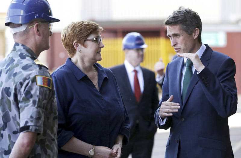 British Defence Secretary Gavin Williamson, right, speaks to Australian Defence Minister Marise Payne