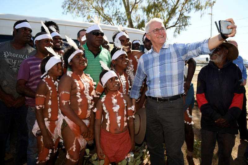 Prime Minister Malcolm Turnbull meets with a local Indigenous dance troupe after arriving at Tennant Creek airport, in the Northern Territory, Sunday, July 22, 2018.